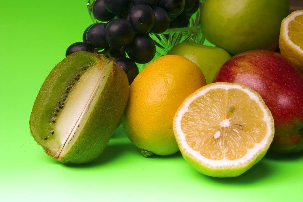 great number of bright and juicy fruit on a green background